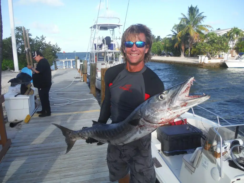 Captain Mike - Your Expert Guide to Lower Keys Marine Life Captain Mike smiling on dock, showcasing his extensive experience with Lower Keys marine life