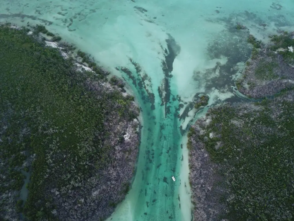 Drone view of crystal-clear ocean channel flowing between Lower Keys islands near Looe Key Reef