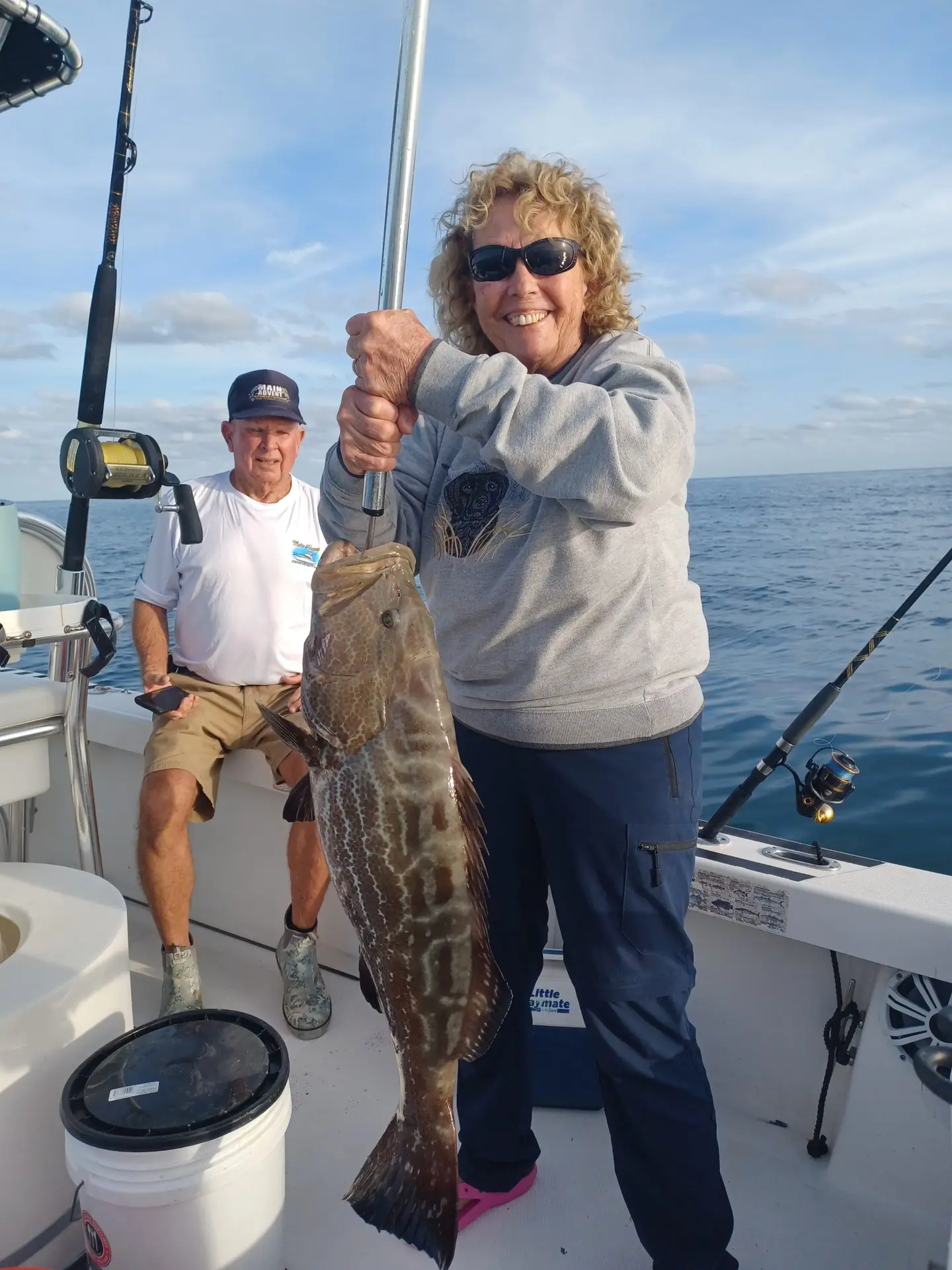 Couple displaying past fish catch during previous Lower Keys charter adventure