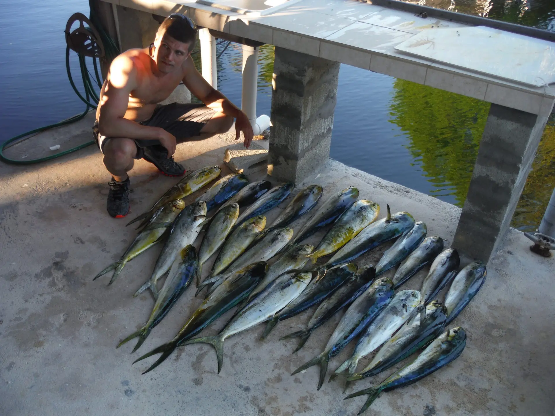 Charter guest proudly displaying catch on Summerland Key dock after Lower Keys fishing adventure
