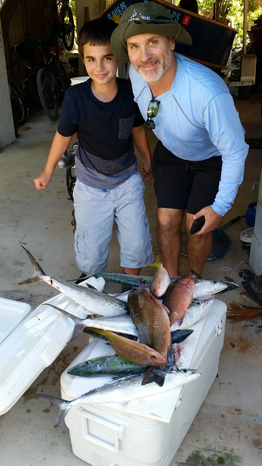 Father and son proudly displaying their catch during Lower Keys family charter adventure