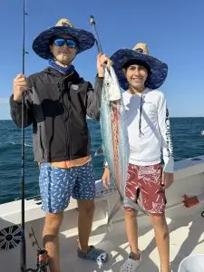 Two guests proudly displaying caught barracuda during Lower Keys charter adventure
