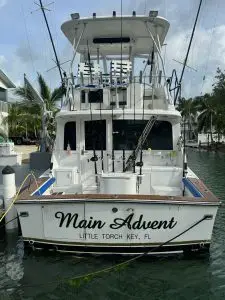 Stern view of main adventure charter vessel in crystal-clear Lower Keys waters departing from Summerland Key